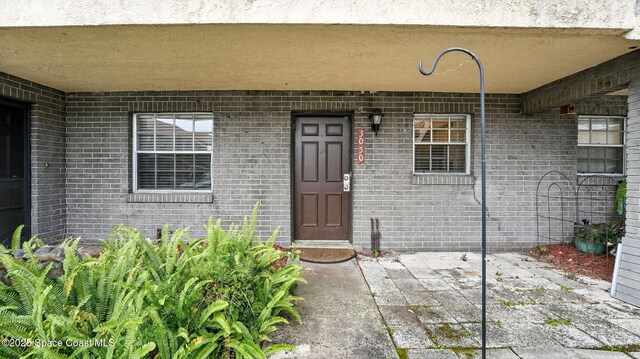 3050 Sir Hamilton Cir Unit 2, Titusville, FL 32780 - view of exterior entry featuring brick siding