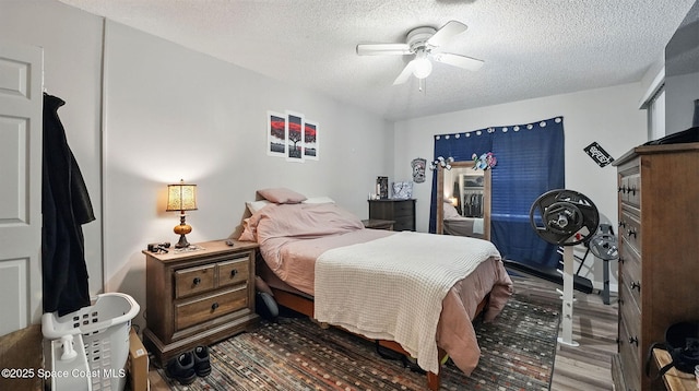 3050 Sir Hamilton Cir Unit 2, Titusville, FL 32780 - bedroom featuring a textured ceiling, dark wood-style floors, and ceiling fan