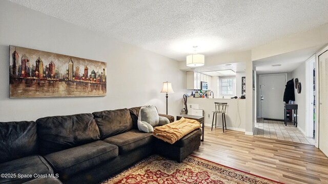 3050 Sir Hamilton Cir Unit 2, Titusville, FL 32780 - living area featuring light wood-style floors and a textured ceiling