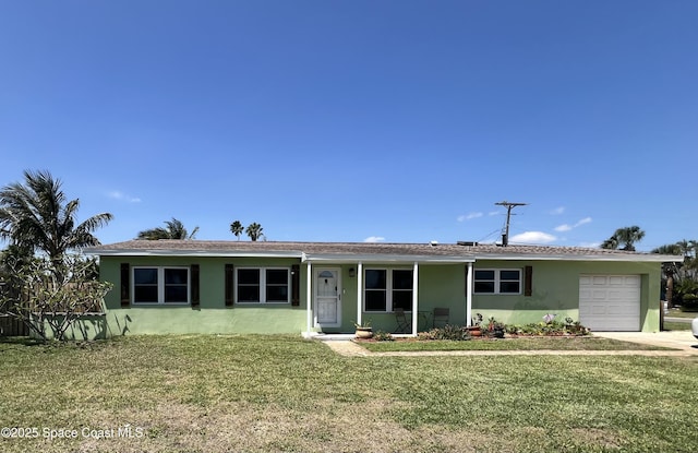 ranch-style home featuring an attached garage, a front yard, and stucco siding
