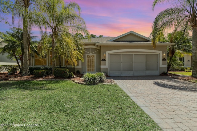 439 Gardendale Cir SE, Palm Bay, FL 32909 - view of front of property with stucco siding, an attached garage, decorative driveway, and a front lawn