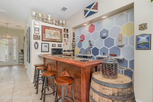 439 Gardendale Cir SE, Palm Bay, FL 32909 - bar with indoor wet bar, tile patterned floors, visible vents, and baseboards