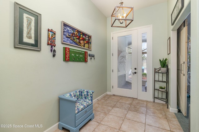 439 Gardendale Cir SE, Palm Bay, FL 32909 - doorway featuring french doors, baseboards, a notable chandelier, and light tile patterned floors