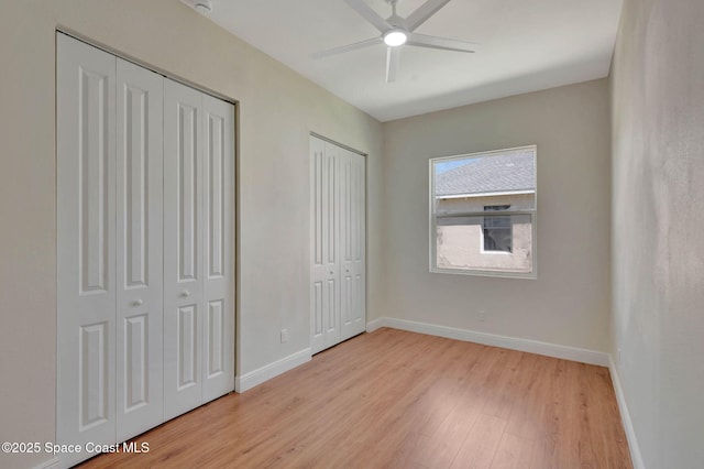 2742 Fling Ave SE, Palm Bay, FL 32909 - unfurnished bedroom with ceiling fan, two closets, baseboards, and light wood-style flooring