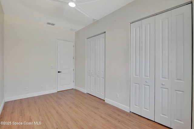 2742 Fling Ave SE, Palm Bay, FL 32909 - unfurnished bedroom featuring visible vents, multiple closets, baseboards, and light wood-style floors