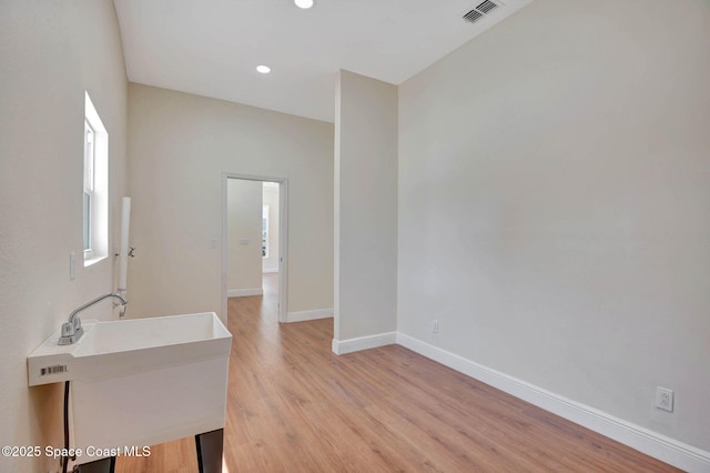 2742 Fling Ave SE, Palm Bay, FL 32909 - unfurnished room with recessed lighting, visible vents, a sink, baseboards, and light wood-style flooring