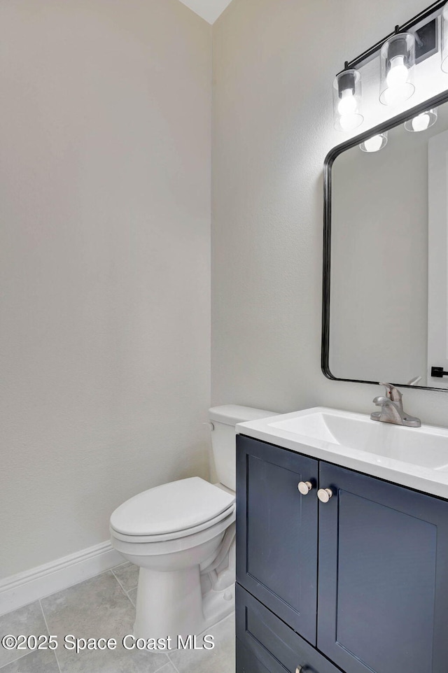 2742 Fling Ave SE, Palm Bay, FL 32909 - bathroom featuring baseboards, vanity, tile patterned flooring, and toilet