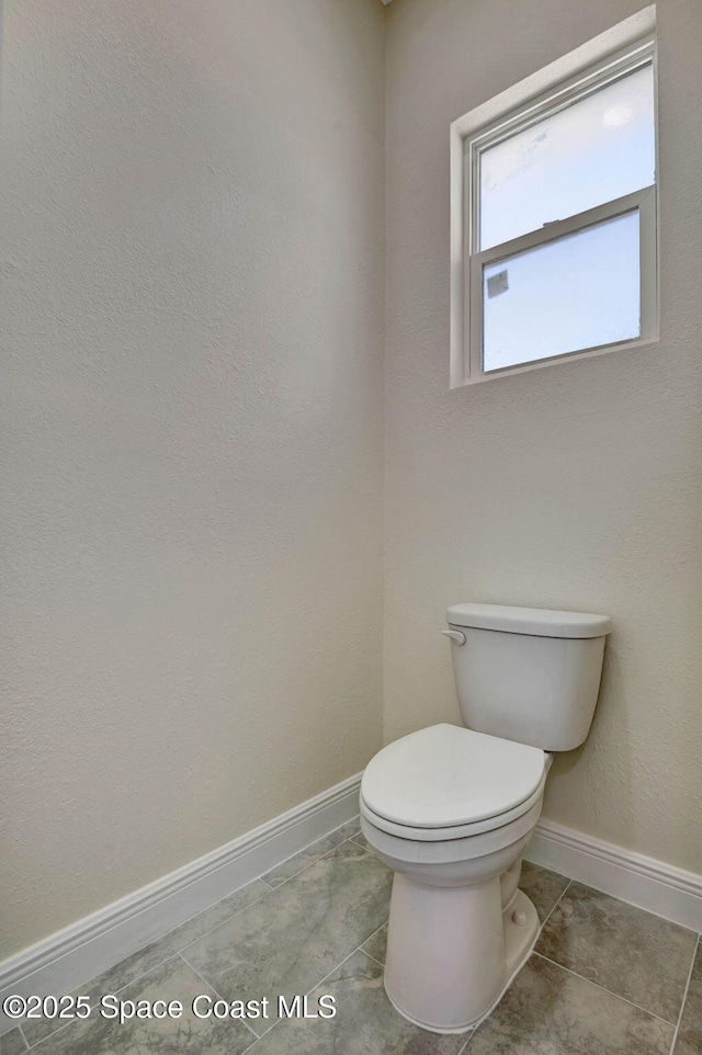 2742 Fling Ave SE, Palm Bay, FL 32909 - bathroom featuring toilet, tile patterned floors, and baseboards