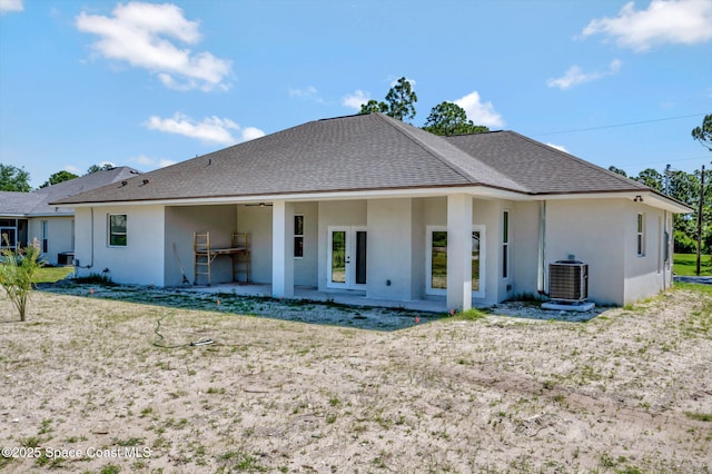 2742 Fling Ave SE, Palm Bay, FL 32909 - back of house featuring a shingled roof, central AC unit, and stucco siding