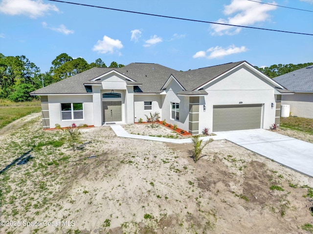 2742 Fling Ave SE, Palm Bay, FL 32909 - view of front of property featuring stucco siding, driveway, and a garage