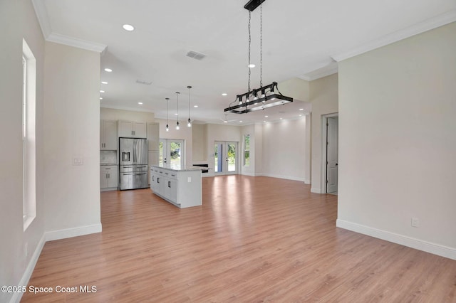 2742 Fling Ave SE, Palm Bay, FL 32909 - kitchen with recessed lighting, open floor plan, light wood finished floors, stainless steel refrigerator with ice dispenser, and a kitchen island