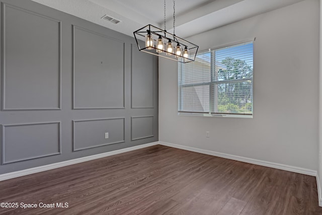 unfurnished dining area featuring baseboards, a notable chandelier, dark wood-type flooring, and visible vents