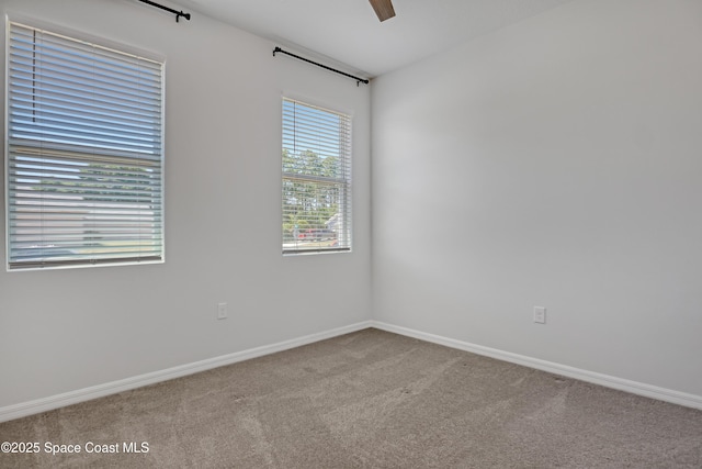 carpeted empty room with baseboards