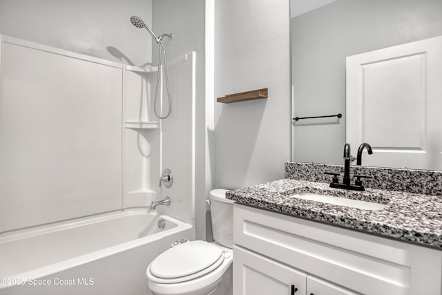 bathroom with toilet, vanity, and  shower combination