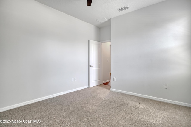 carpeted spare room with visible vents and baseboards
