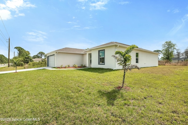 view of front of home with concrete driveway, an attached garage, a front lawn, and stucco siding