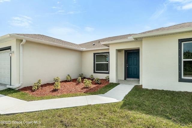 property entrance with a garage, a lawn, stucco siding, and roof with shingles