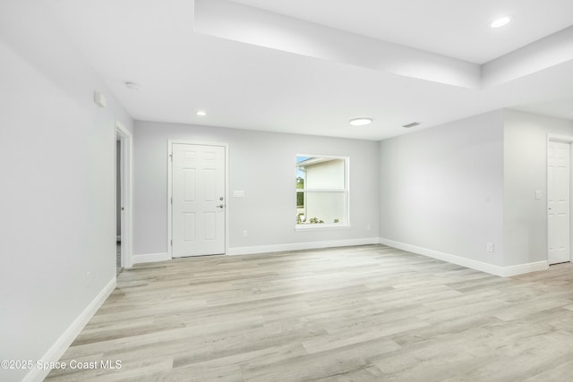 unfurnished room featuring baseboards, visible vents, light wood finished floors, and recessed lighting
