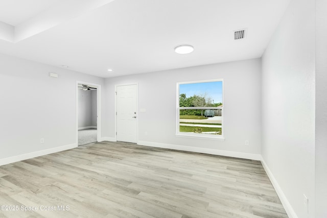 empty room with recessed lighting, wood finished floors, visible vents, and baseboards