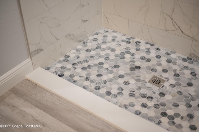 interior details featuring a tile shower
