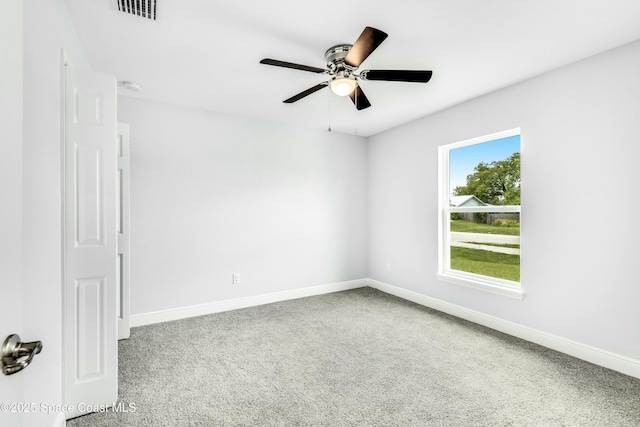 carpeted empty room featuring ceiling fan, baseboards, and visible vents