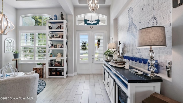 3630 Kite St, Titusville, FL 32796 - interior space with dark countertops, a notable chandelier, pendant lighting, and light wood-style flooring