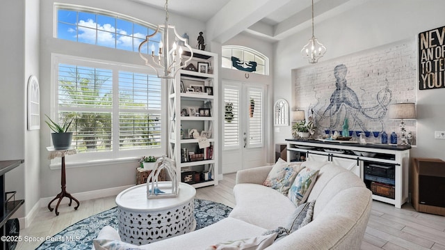 3630 Kite St, Titusville, FL 32796 - living area with wood finished floors, a high ceiling, and a chandelier