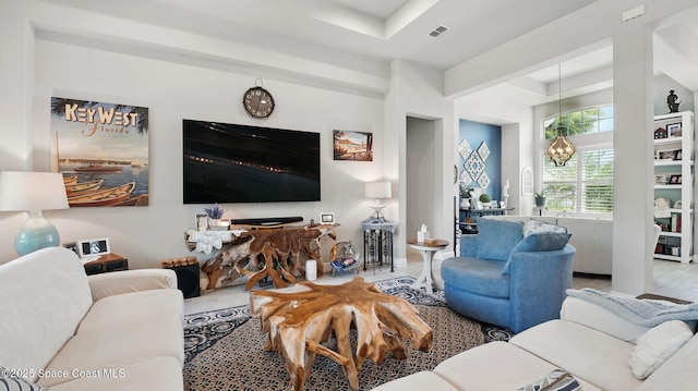 3630 Kite St, Titusville, FL 32796 - living area featuring a notable chandelier, visible vents, and a raised ceiling