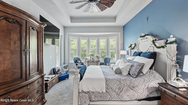 3630 Kite St, Titusville, FL 32796 - bedroom featuring a raised ceiling, carpet floors, a ceiling fan, and multiple windows