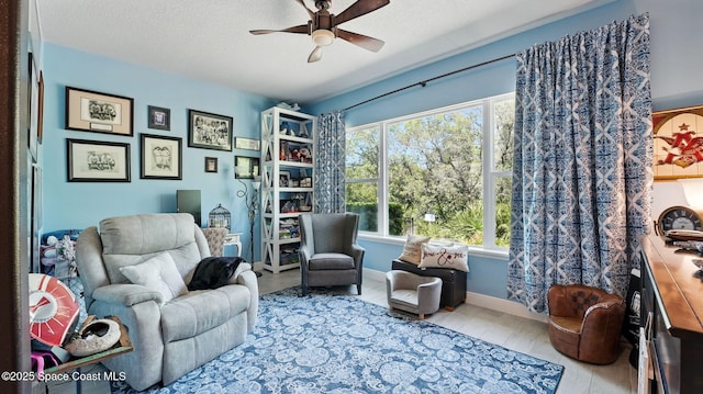 3630 Kite St, Titusville, FL 32796 - living area featuring wood finished floors, a textured ceiling, baseboards, and ceiling fan