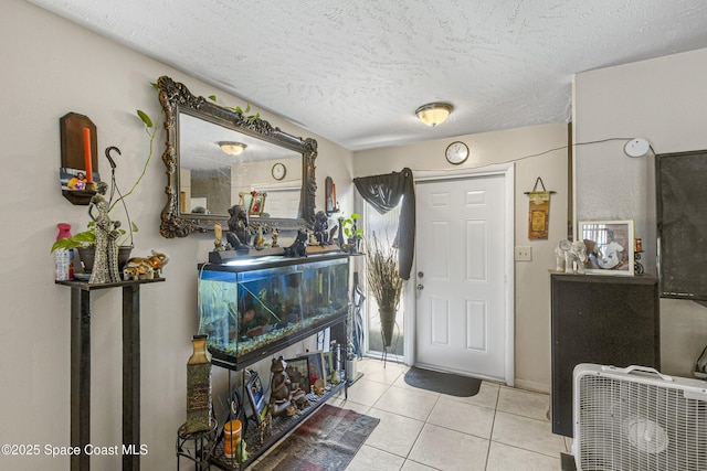 entrance foyer featuring a textured ceiling and tile patterned flooring
