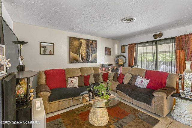 tiled living area with visible vents and a textured ceiling