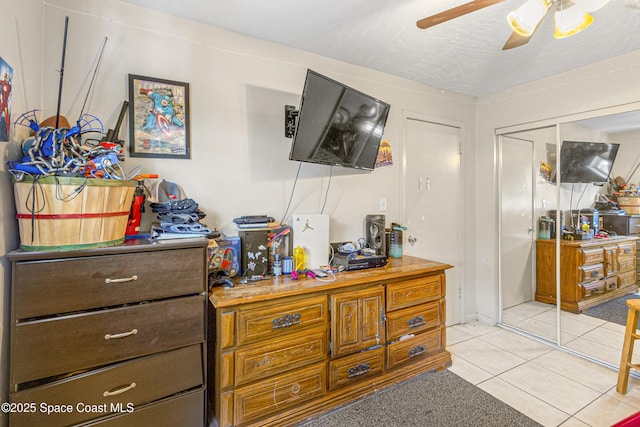 bedroom with ceiling fan and light tile patterned floors