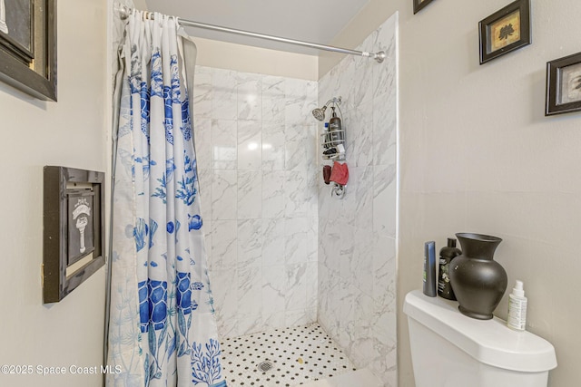 full bath featuring toilet and a stall shower