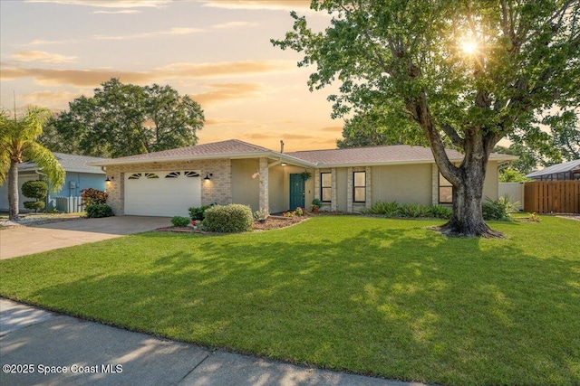 2873 Sanders Ct, Melbourne, FL 32935 - ranch-style home featuring an attached garage, fence, driveway, and a front lawn