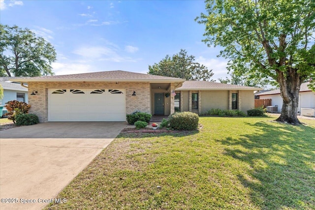 2873 Sanders Ct, Melbourne, FL 32935 - single story home with brick siding, an attached garage, a front lawn, and concrete driveway