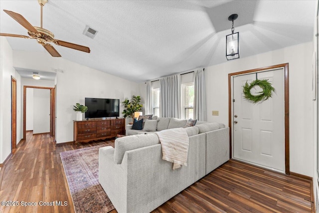 2873 Sanders Ct, Melbourne, FL 32935 - living area with dark wood finished floors, lofted ceiling, visible vents, and a ceiling fan