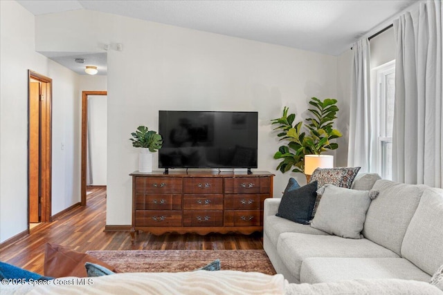 2873 Sanders Ct, Melbourne, FL 32935 - living area featuring baseboards, vaulted ceiling, and dark wood-style floors