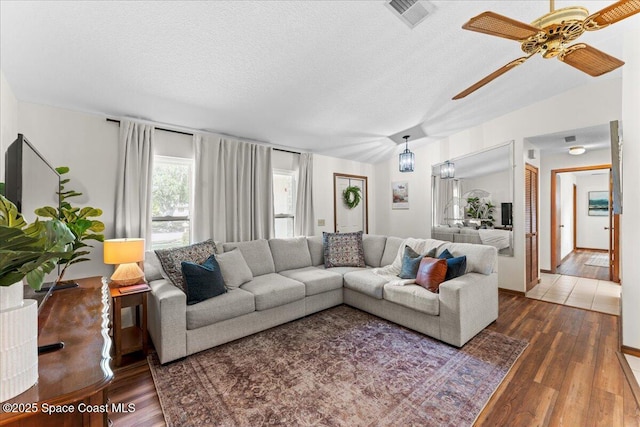 2873 Sanders Ct, Melbourne, FL 32935 - living room featuring a ceiling fan, wood finished floors, visible vents, and a textured ceiling