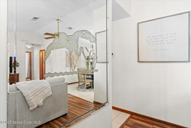 2873 Sanders Ct, Melbourne, FL 32935 - tiled living area with lofted ceiling, a ceiling fan, baseboards, and visible vents