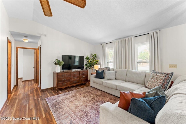 2873 Sanders Ct, Melbourne, FL 32935 - living room with dark wood-style floors, vaulted ceiling, a ceiling fan, baseboards, and a textured ceiling