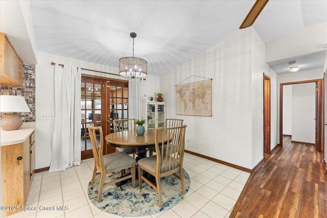 2873 Sanders Ct, Melbourne, FL 32935 - dining room with baseboards, a notable chandelier, and french doors