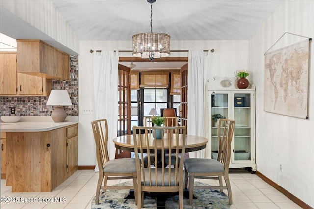 2873 Sanders Ct, Melbourne, FL 32935 - dining area with baseboards, a chandelier, and light tile patterned floors