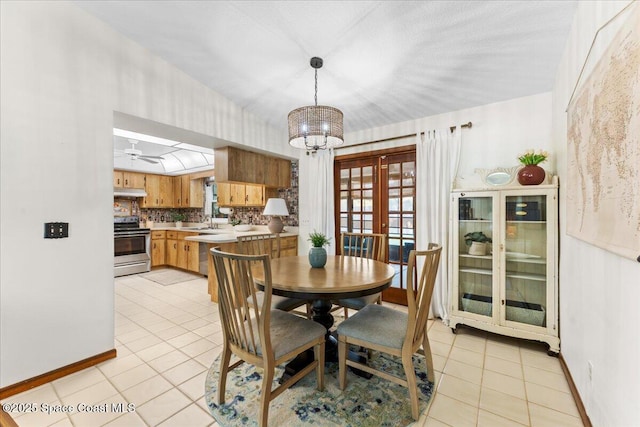 2873 Sanders Ct, Melbourne, FL 32935 - dining space featuring an inviting chandelier, baseboards, french doors, and light tile patterned floors