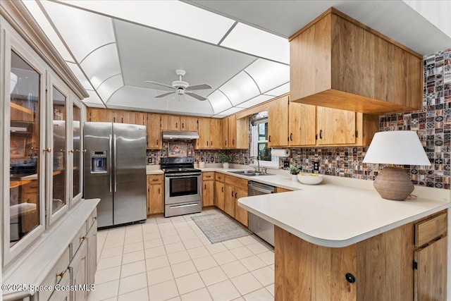 2873 Sanders Ct, Melbourne, FL 32935 - kitchen featuring a peninsula, decorative backsplash, appliances with stainless steel finishes, light countertops, and light tile patterned floors