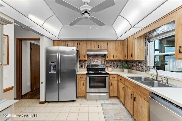 2873 Sanders Ct, Melbourne, FL 32935 - kitchen with stainless steel appliances, light countertops, under cabinet range hood, and a sink
