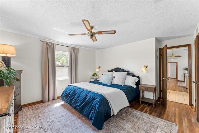 2873 Sanders Ct, Melbourne, FL 32935 - bedroom with baseboards, a ceiling fan, wood finished floors, and a textured ceiling