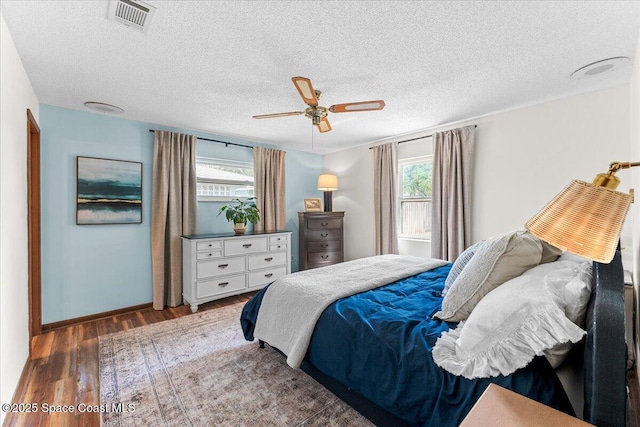 2873 Sanders Ct, Melbourne, FL 32935 - bedroom featuring a ceiling fan, wood finished floors, a textured ceiling, baseboards, and visible vents