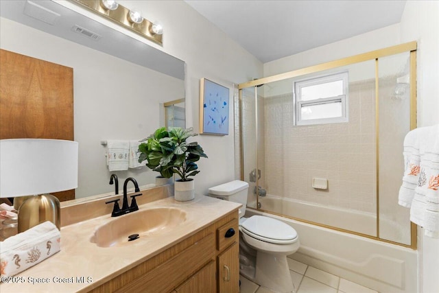 2873 Sanders Ct, Melbourne, FL 32935 - full bathroom featuring tile patterned floors, toilet, visible vents, vanity, and enclosed tub / shower combo