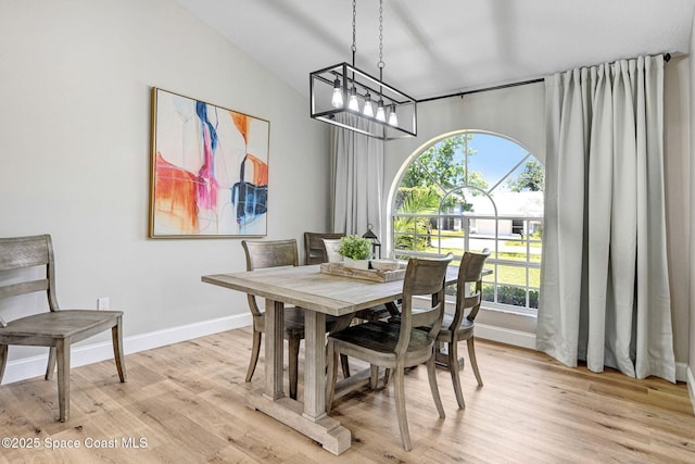 3360 Holly Springs Rd, Melbourne, FL 32934 - dining space with vaulted ceiling, baseboards, a chandelier, and light wood-type flooring